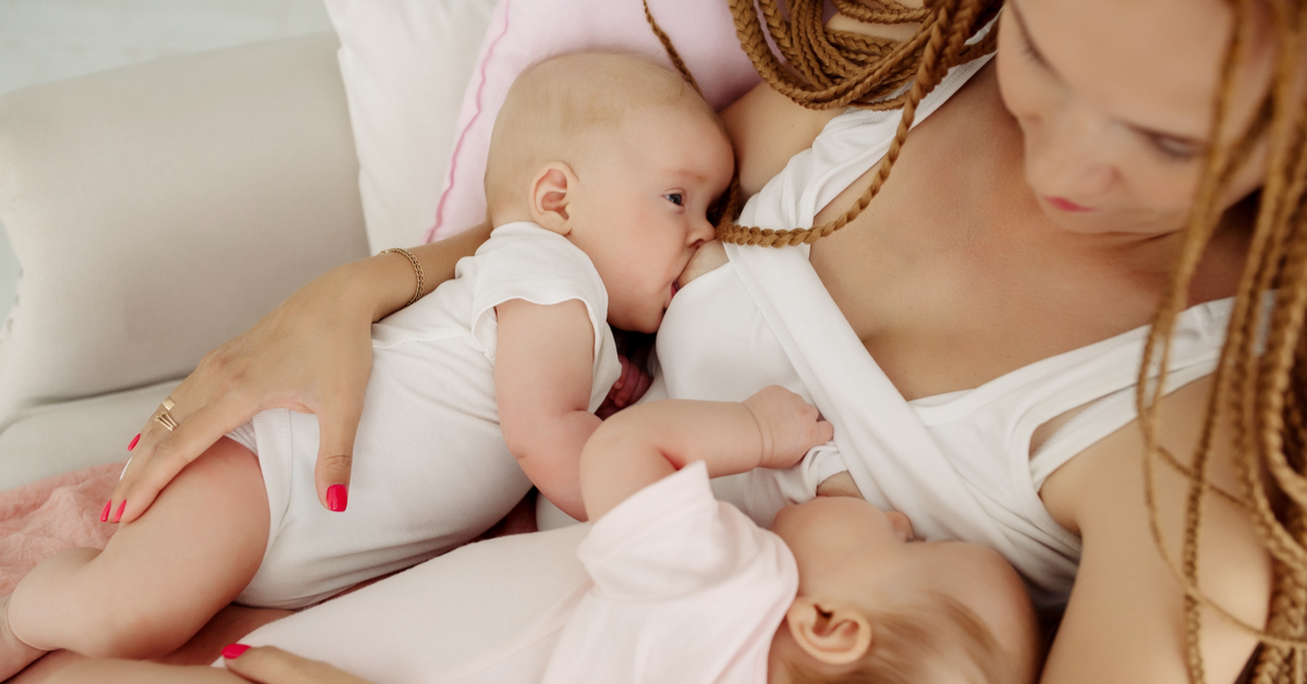 How should twin babies be breastfeed?